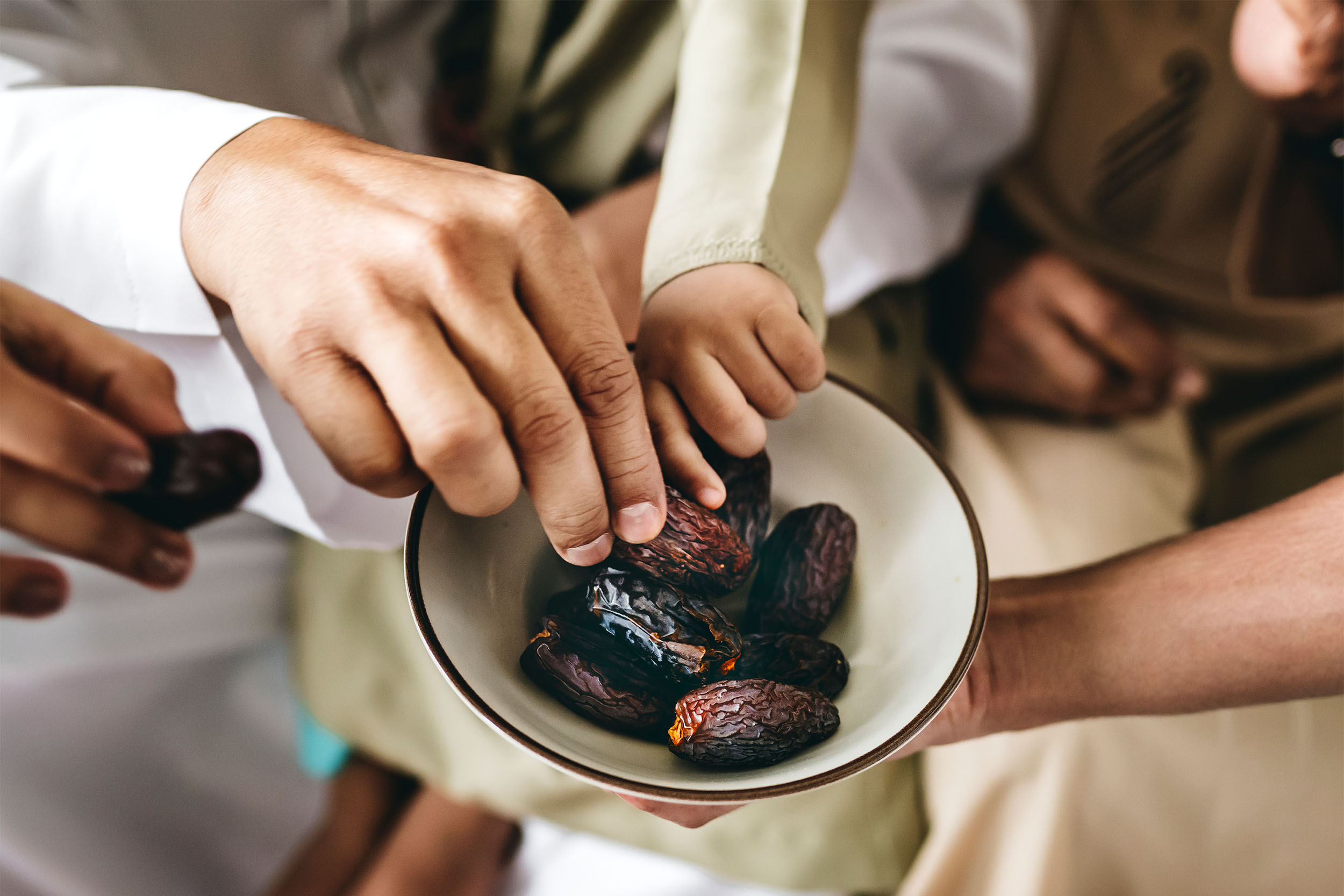 top view woman eating dry persimmon with tea and mix of nuts and chocolate on the table